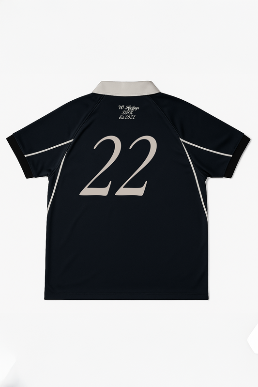 Flat lay of back view of Version Originale’s black Version Classique jersey with beige number 22, beige piping along sleeves and sides, beige collar, and “VO Heritage DHK Est. 2022” text below the neckline