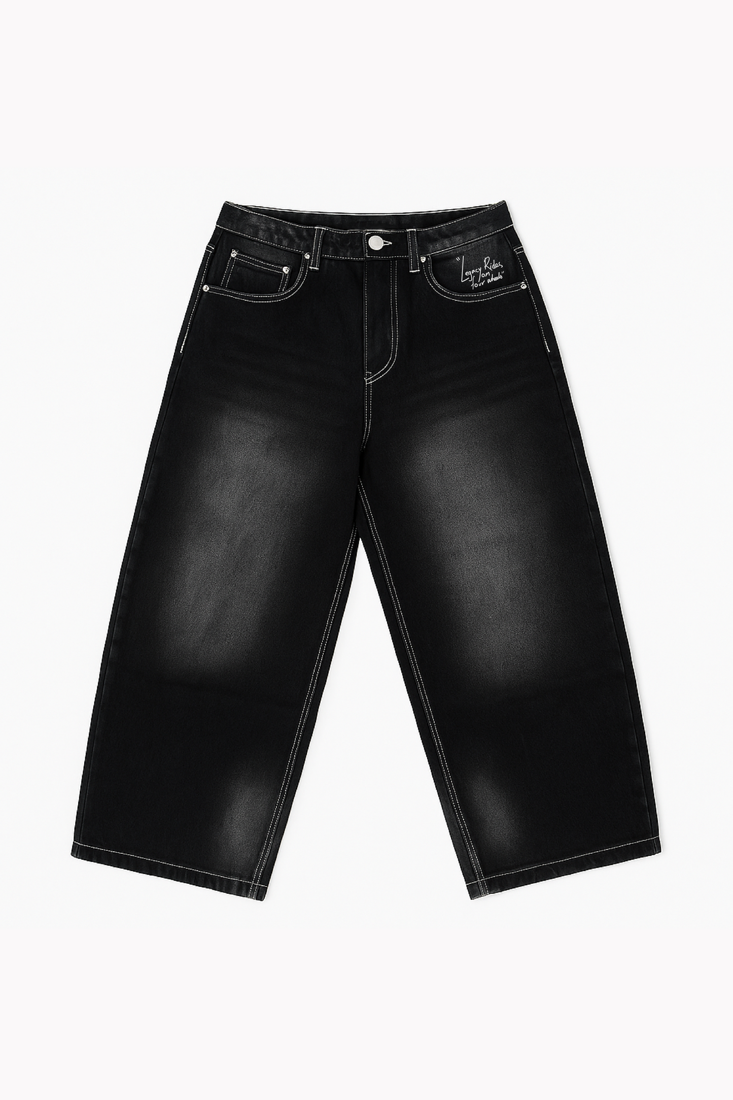 Flat lay of Version Originale’s black Tony Hawk jeans with faded detailing and “Legacy Rides on Four Wheels” print above the left pocket