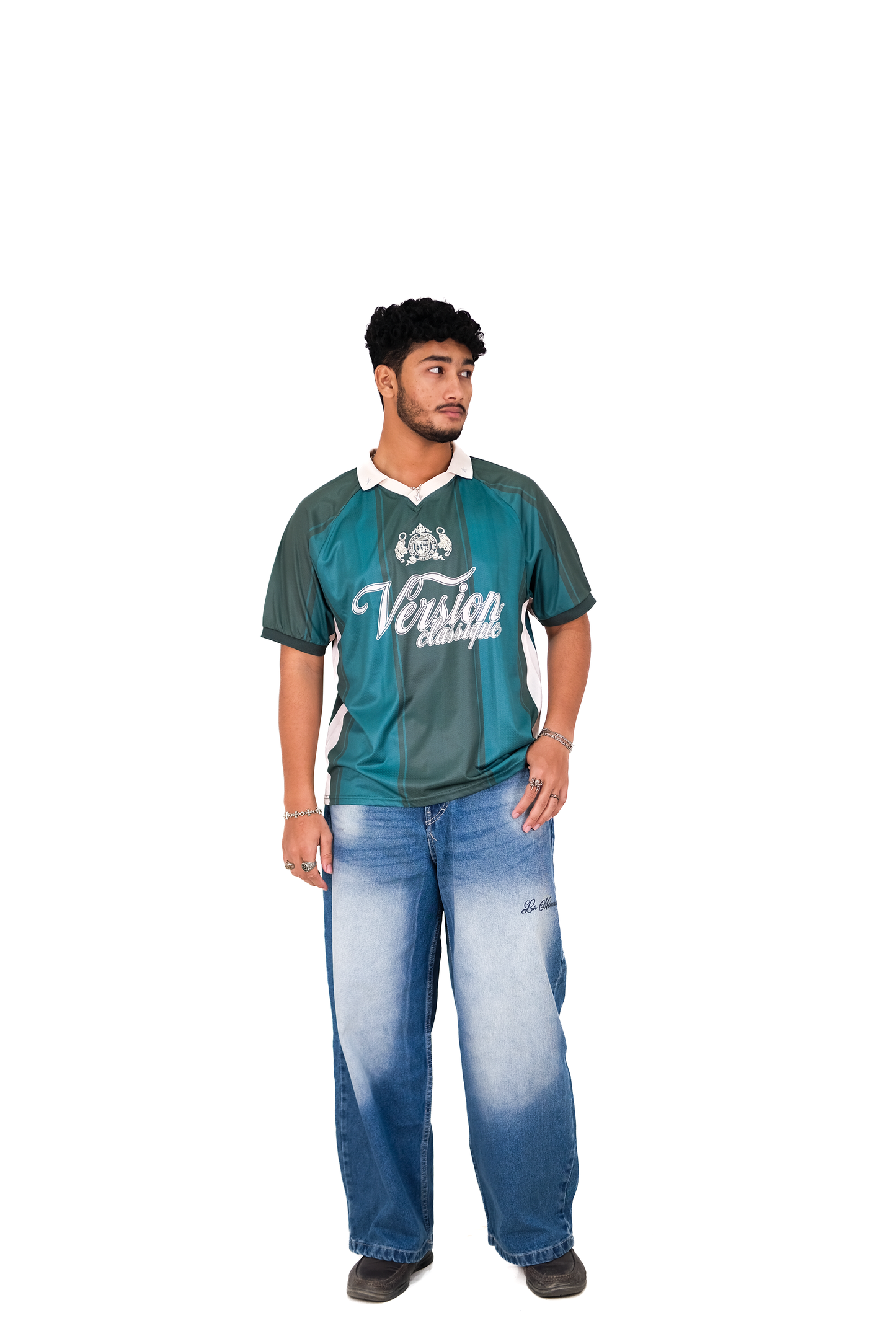 Model wearing Version Originale’s green Version Classique athletic jersey with beige side panels, green vertical panel detailing, and crest logo, paired with Version Originale’s blue faded La Mémoire baggy jeans
