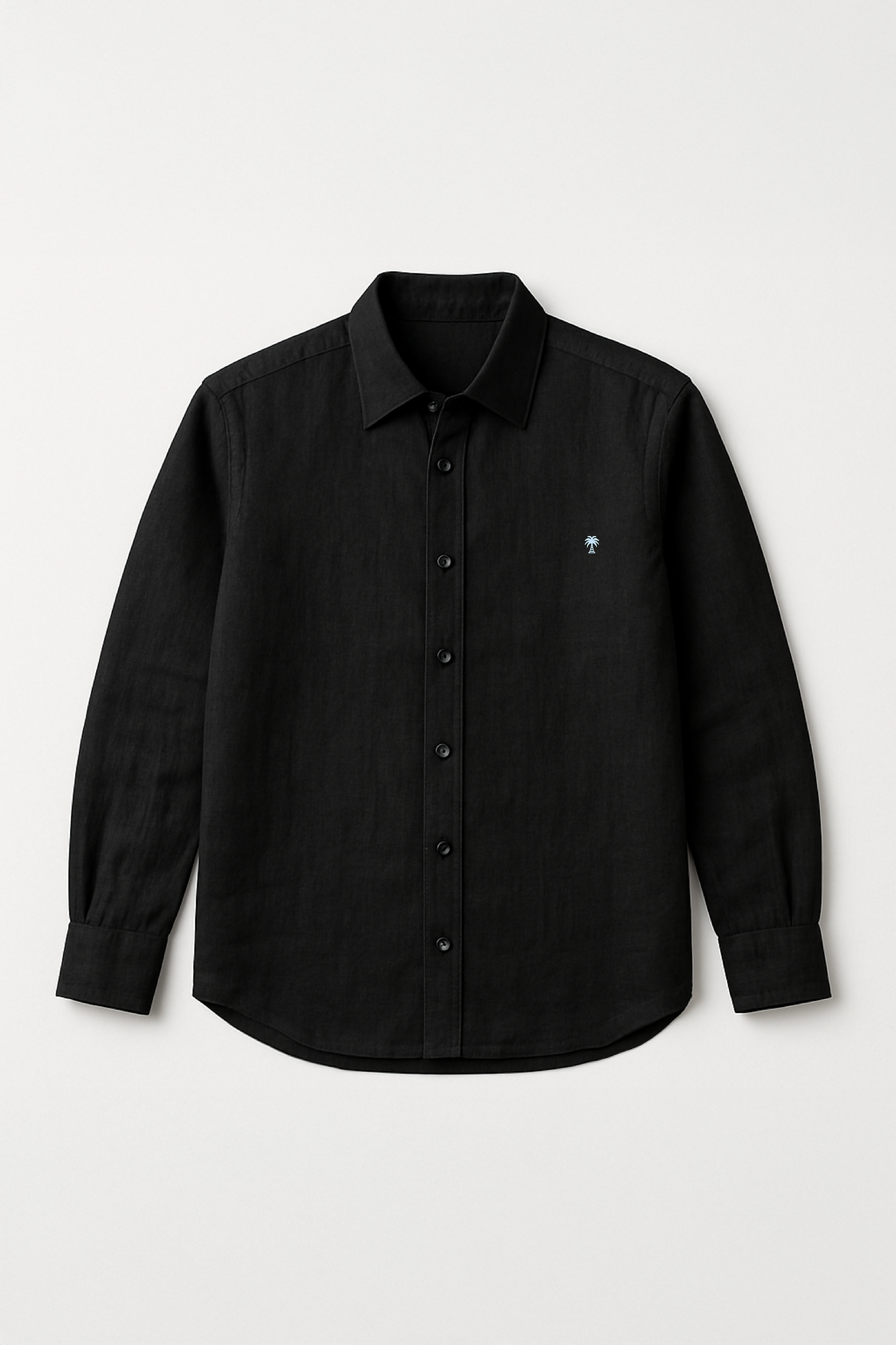 Flat lay of Version Originale's classic black linen shirt featuring a full button-down front and subtle palm tree embroidery on the chest