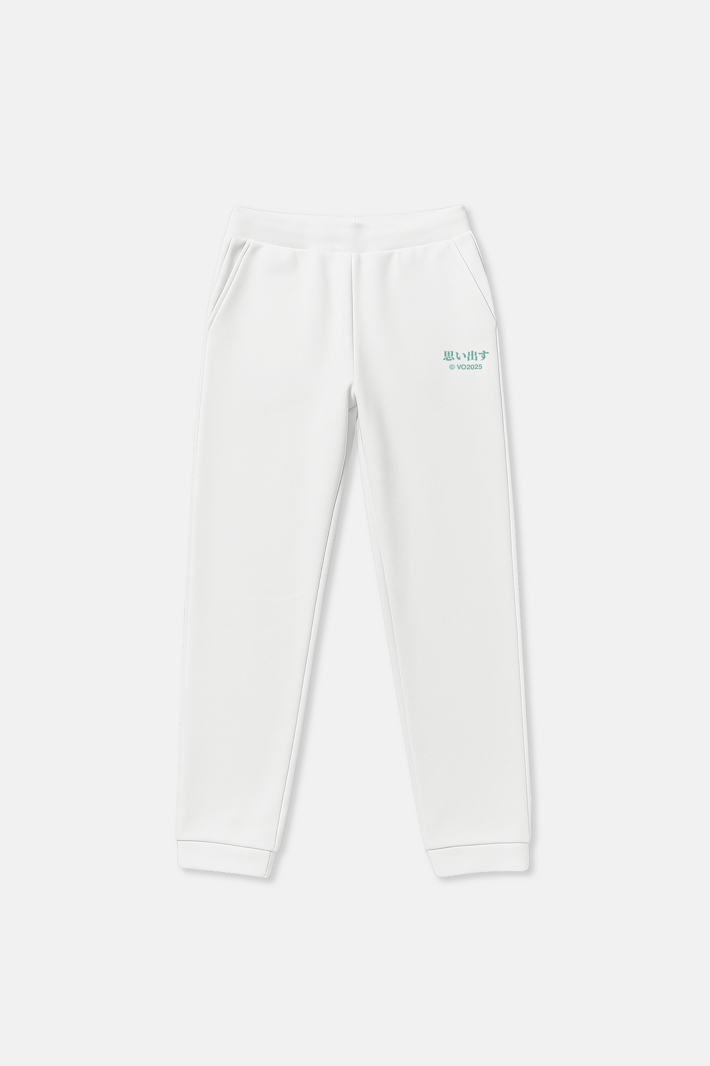 White sweatpants with green Japanese text print on a light background